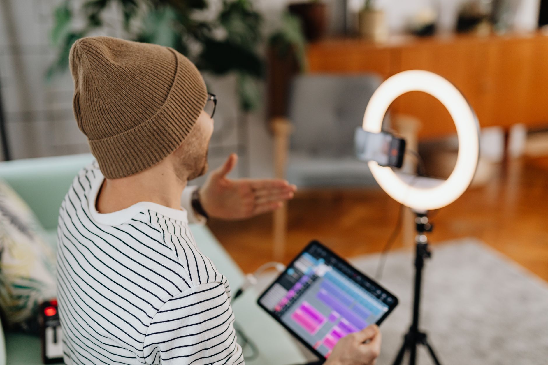 Content creator recording a voice message at a desk with a microphone