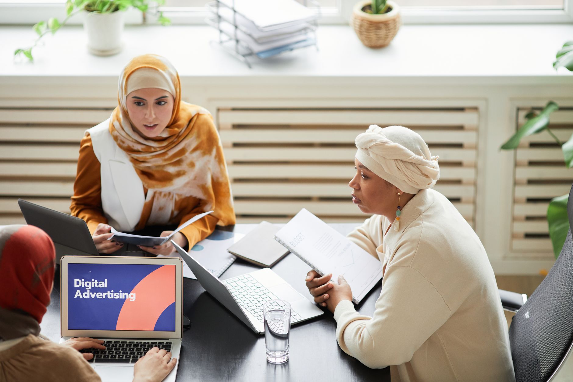 A small marketing team reviewing video content together on a monitor