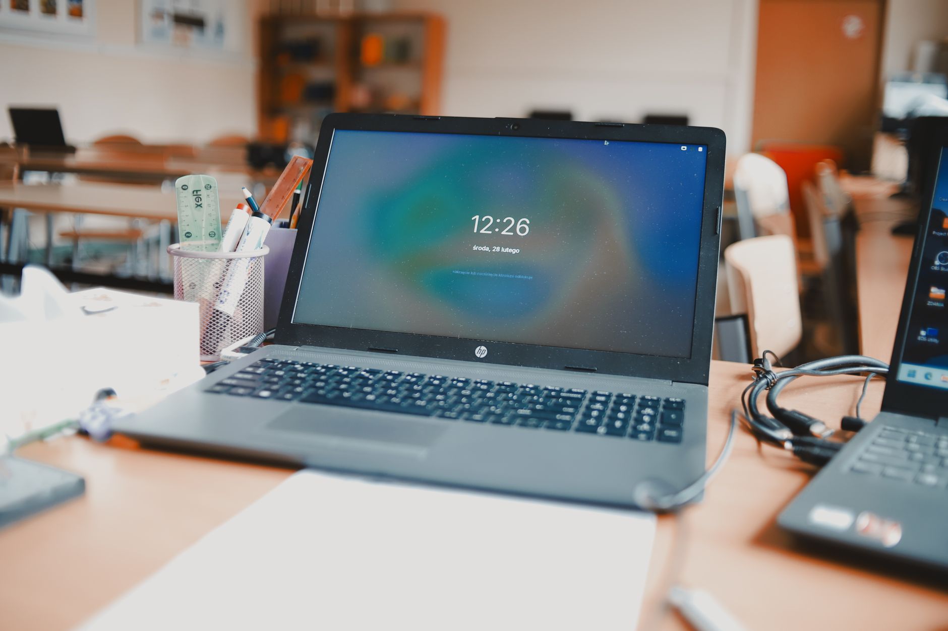 Laptop screen displaying design and presentation software tools open on a desk
