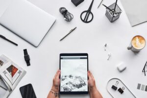 Clean desk workspace with laptop and notebook representing digital productivity tools