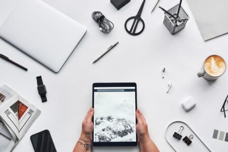 Clean desk workspace with laptop and notebook representing digital productivity tools