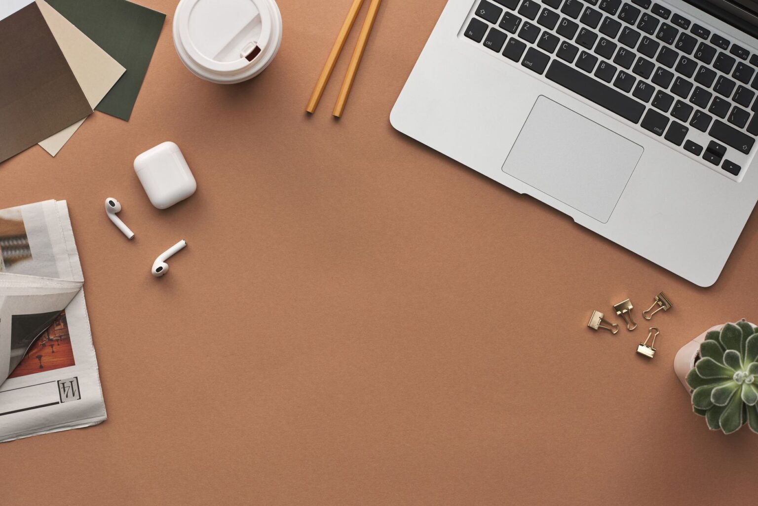 Beehiiv’s Web Builder Is Quietly Replacing Squarespace for Newsletter Brands A clean desk workspace with a laptop open to a newsletter publishing dashboard