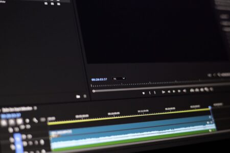 Person editing a short-form video on a computer screen with caption overlays visible