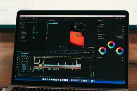 A person editing video content on a computer screen at a desk