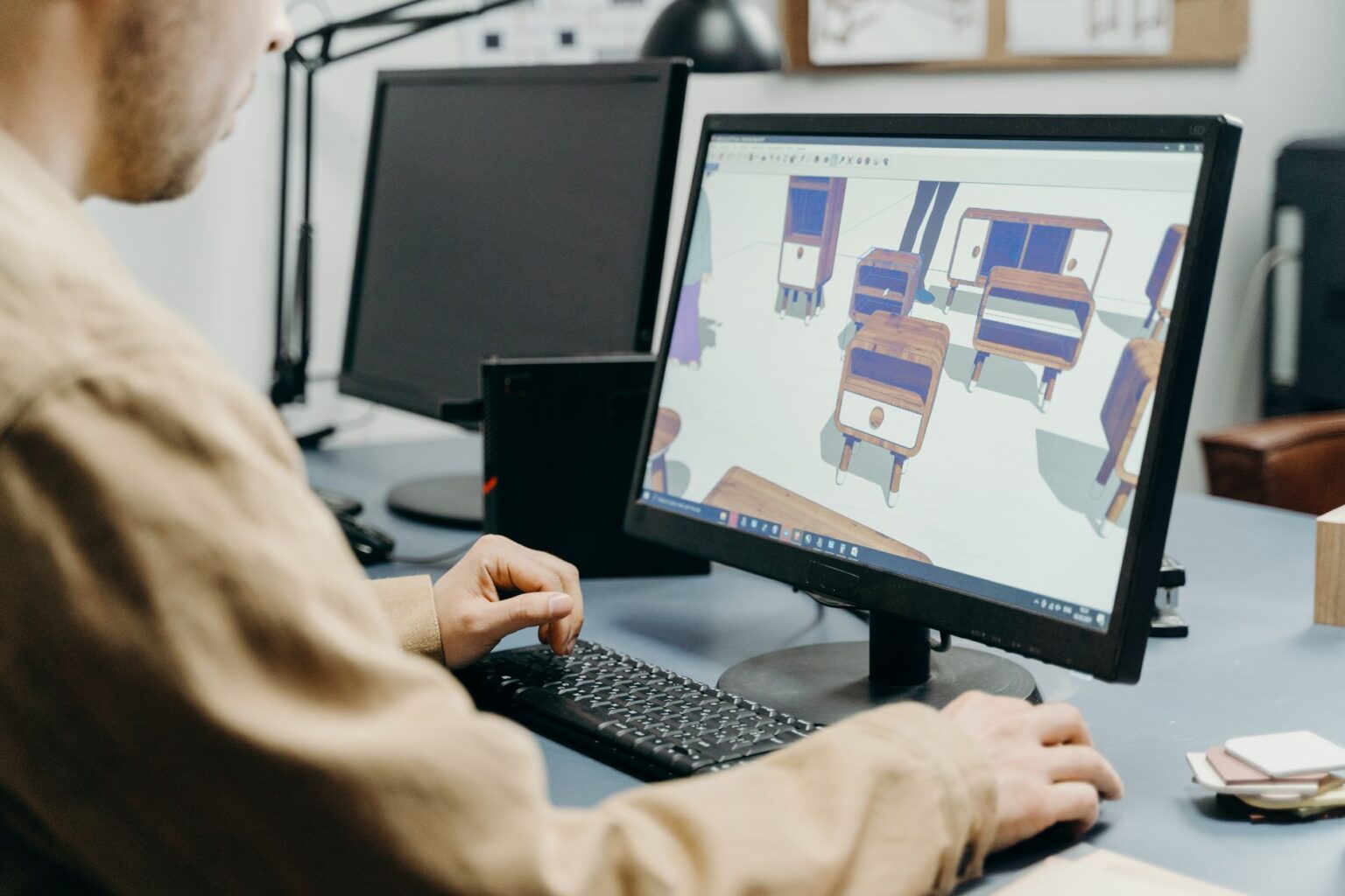 Figma’s Dev Mode Is Quietly Replacing Zeplin for Social Asset Handoffs Designer reviewing a digital interface on a large monitor in a studio setting