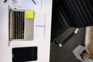 A clean workspace with a laptop open to a digital form builder tool