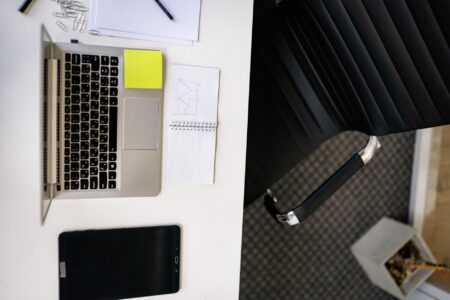 A clean workspace with a laptop open to a digital form builder tool