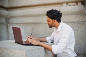 A content creator working on a laptop, building a subscription platform