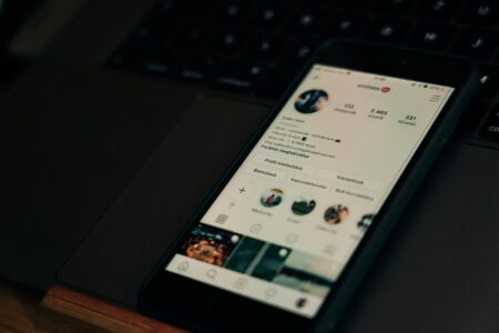 Person browsing a brand's social media profile on a smartphone