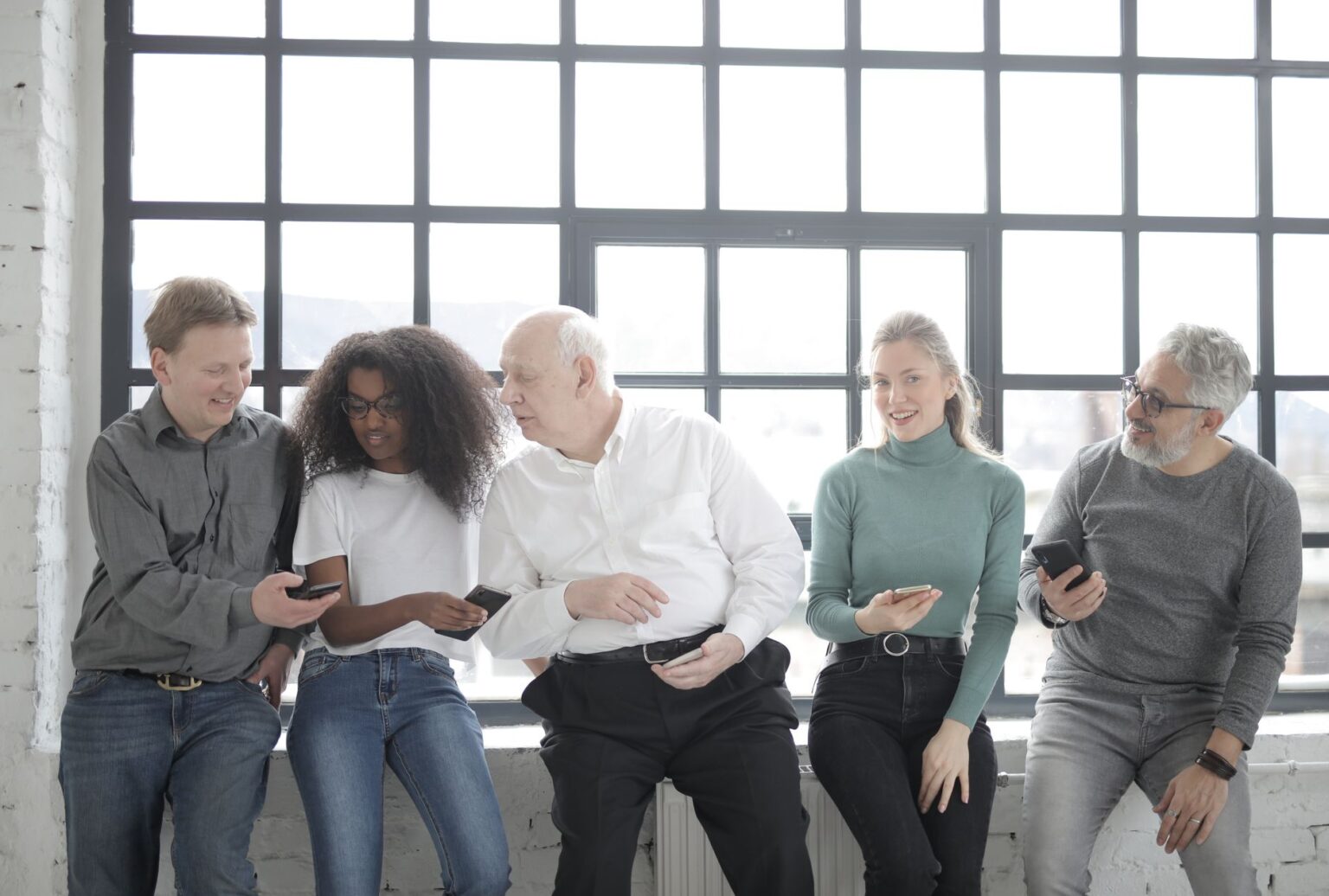 A social media marketing team reviewing content on laptops in a modern office