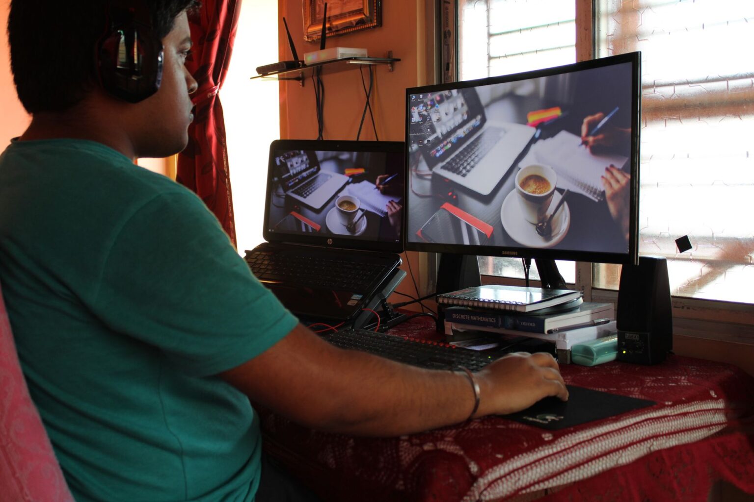 Freelancer working at a desk with multiple screens showing analytics dashboards