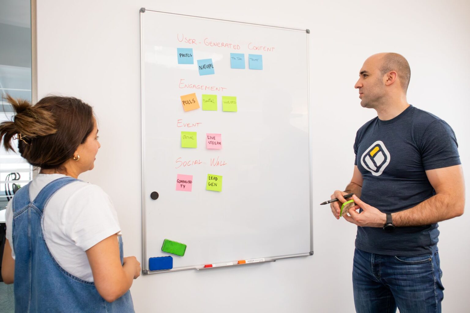 Marketing team reviewing creative inspiration on a digital board in an office setting