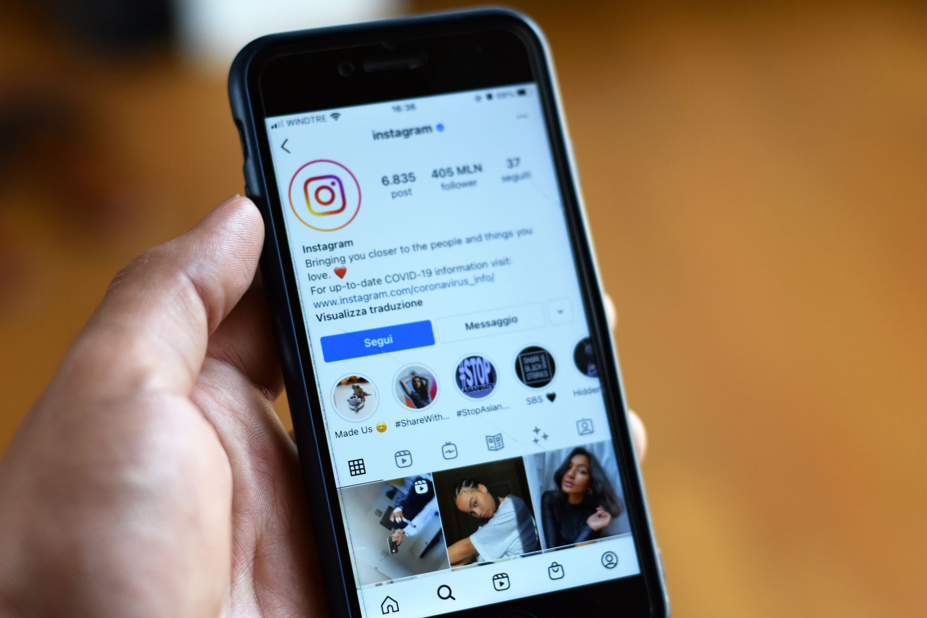 Person scrolling through social media feed on smartphone