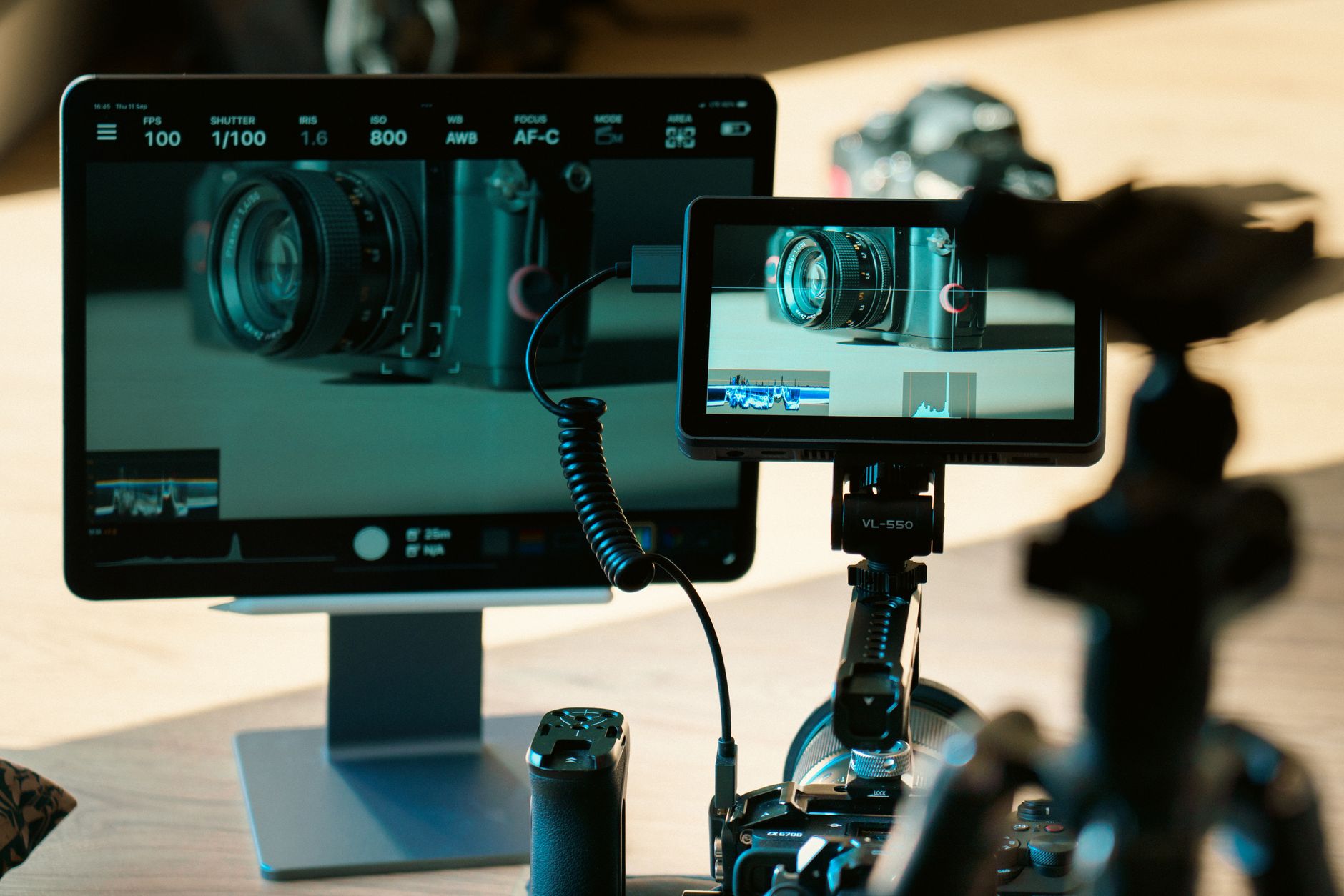 A content producer managing a video rendering workflow on a multi-screen workstation